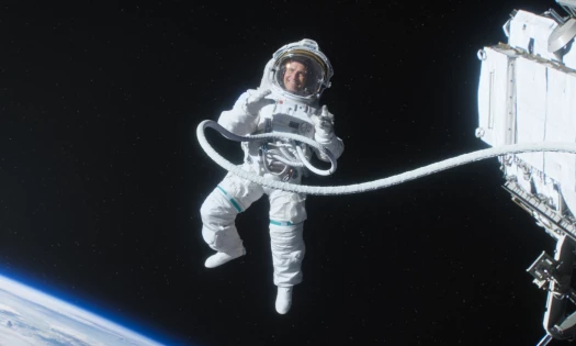 An astronaut in space, smiling