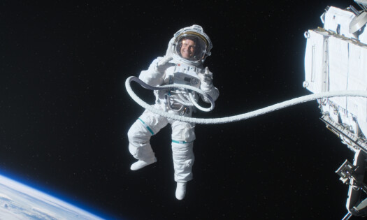 An astronaut in space, smiling