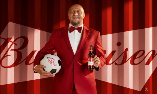 Roberto Carlos holding a football and a bottle of Budweiser