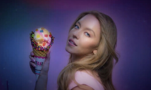Sydney Sweeney posing sexily with a Baskin-Robbins rainbow sherbet cone