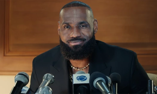 Lebron James in a press conference, smiling at the crowd