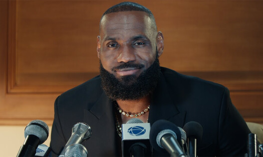 Lebron James in a press conference, smiling at the crowd