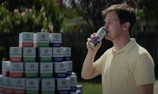 A man drinking a can of Kul Mocks