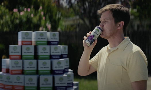 A man drinking a can of Kul Mocks