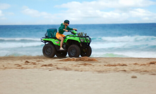 A woman riding an RV by the beach