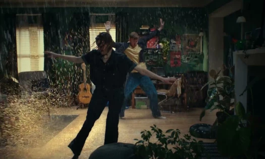 Two people dancing in a raining living room