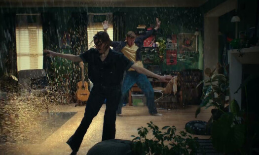 Two people dancing in a raining living room