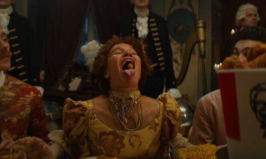 A woman catching a piece of KFC with her mouth