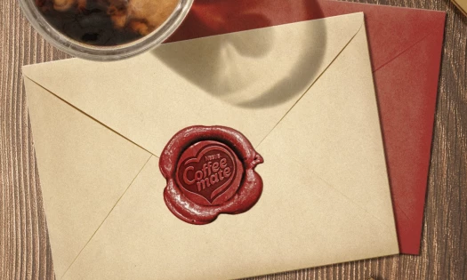 An envelope with a "Coffee mate" stamp on it