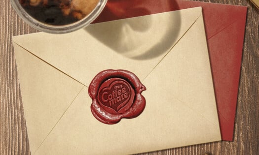 An envelope with a "Coffee mate" stamp on it