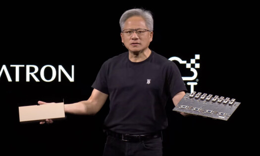 Nvidia CEO Jensen Huang on stage holding a server in each hand during GTC Paris Keynote at VivaTech 2025