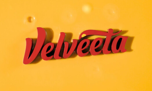 The Velveeta logo against a cheesy backdrop