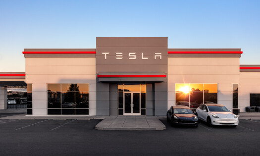 A Tesla shop with two cars parked outside