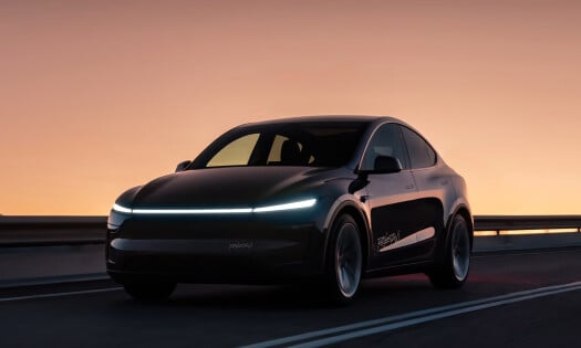A black Tesla Robotaxi on the road