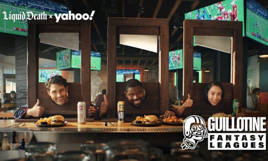 Three people smiling while their heads are caught in a guiloitine