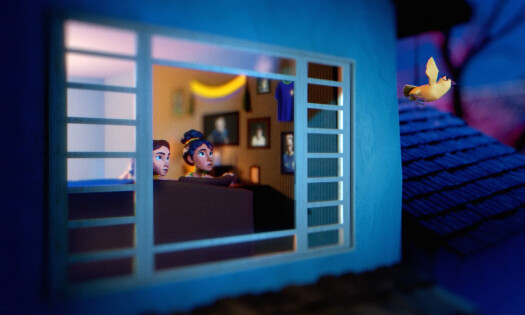 Two women look outside a window