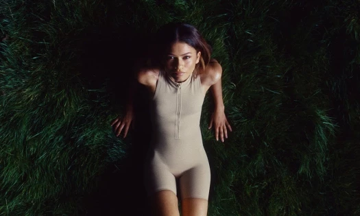 Zendaya lying down on grass