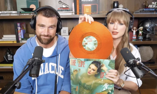 Travis Kelce and Taylor Swift showing off her new orange album on the New Heights podcast with Jason Kelce