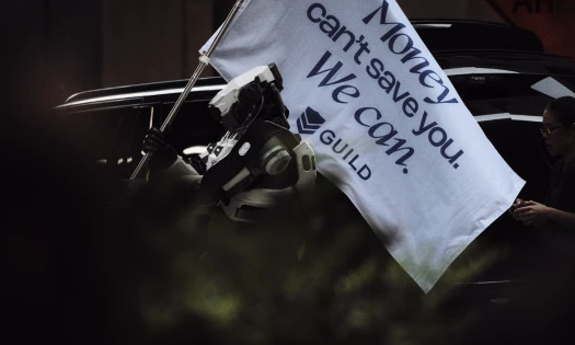 A robote raises a Guild flag