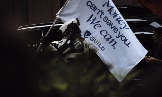 A robote raises a Guild flag