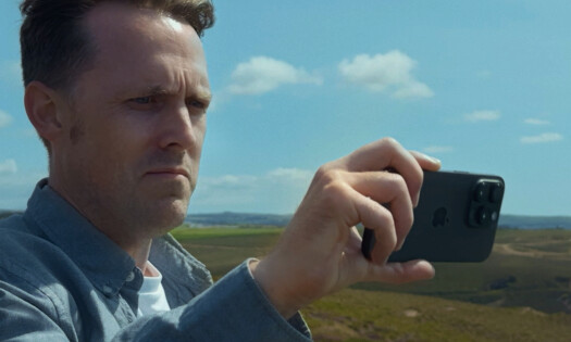 A man holding up his iPhone 16 Pro