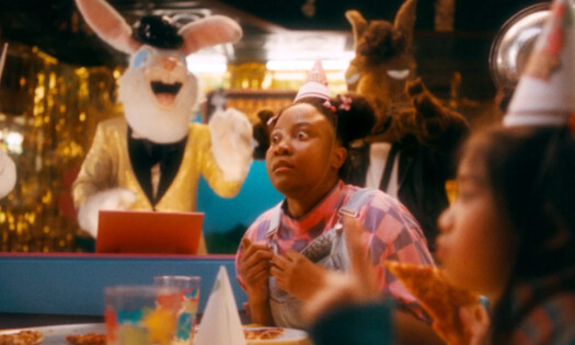 A woman in a party is surprised by animal animatronics