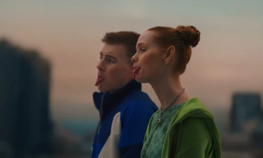 Two people look into the distance as their tongues are tied
