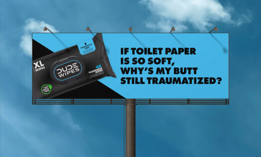 A DUDE Wipes billboard that writes: "If toilet paper is so soft, why's my butt still traumatized?"