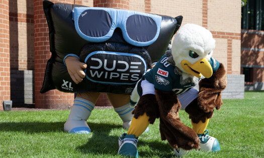 The DUDE Wipes and Philadelphia Eagles mascots on a field