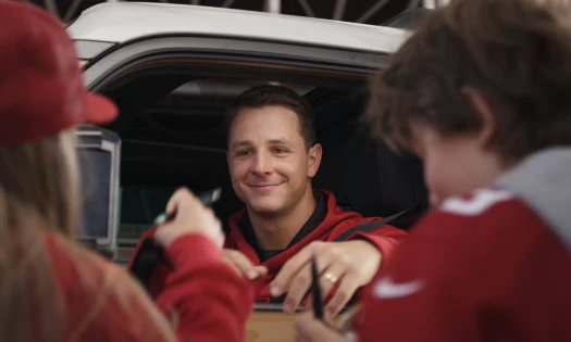Brock Purdy inside his Toyota about to sign autographs for fans