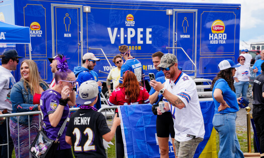 Fans having fun outside the V.I.PEE porta-potties