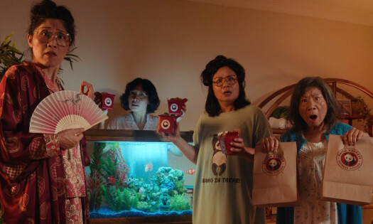 Five aunties look surprised as they hold up Panda Express takeout