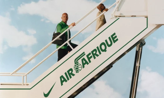 A man going up the airplane stairs