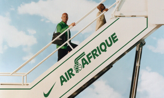 A man going up the airplane stairs