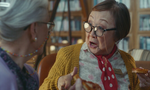 Two elderly women speaking to each other