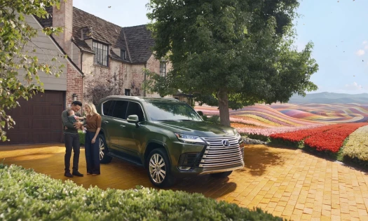 A family and their Lexus vehicle beside a scenic field