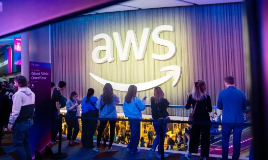 People gather during the recent AWS Summit showing the AWS logo