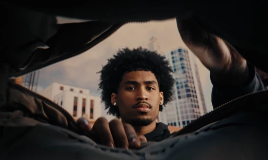 A basketball star looks into a bag