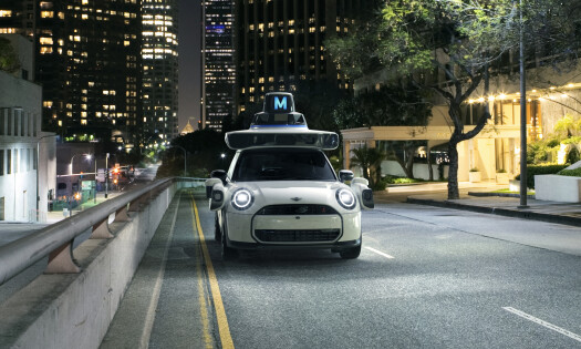 MINI USA's "ghost car" on a well-lit road at night