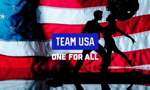 The silhouette of two people dancing in front of the American flag