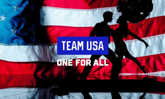 The silhouette of two people dancing in front of the American flag