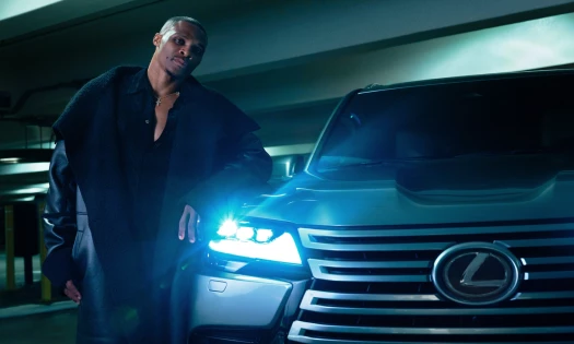 Russell Westbrook standing beside a Lexus vehicle