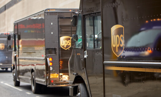 UPS delivery vehicles lined up on the road
