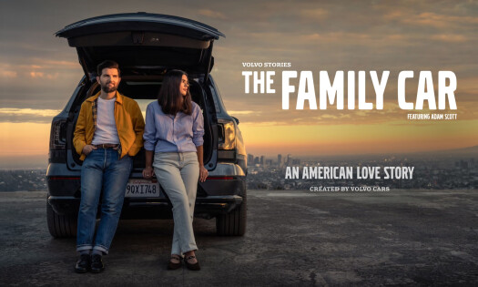 Adam Scott and daughter Frankie leaning against an open trunk of a Volvo SUV