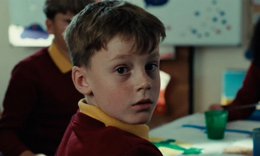 A young boy looking back