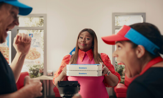 Retta with boxes of Domino's