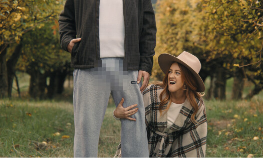 A woman with a scarecrow wearing gray pants