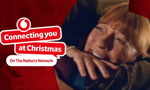 mom embracing son on a christmas video