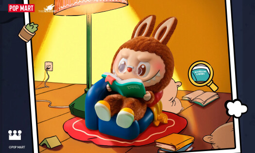 A Labubu reading a book on a couch for the new "The Monsters" series figures
