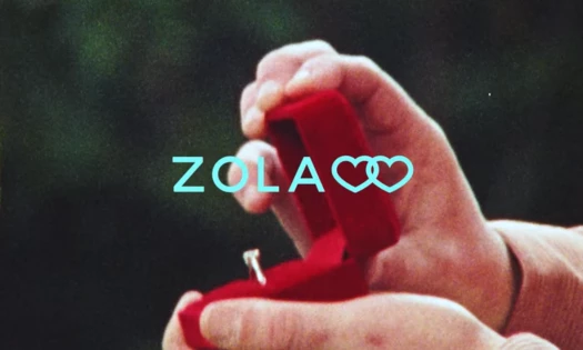 man hand with an engagement ring in a red box Zola